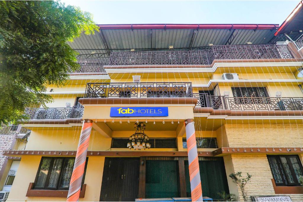 a building with a sign that reads job units at FabHotel Harmony in Colonelganj