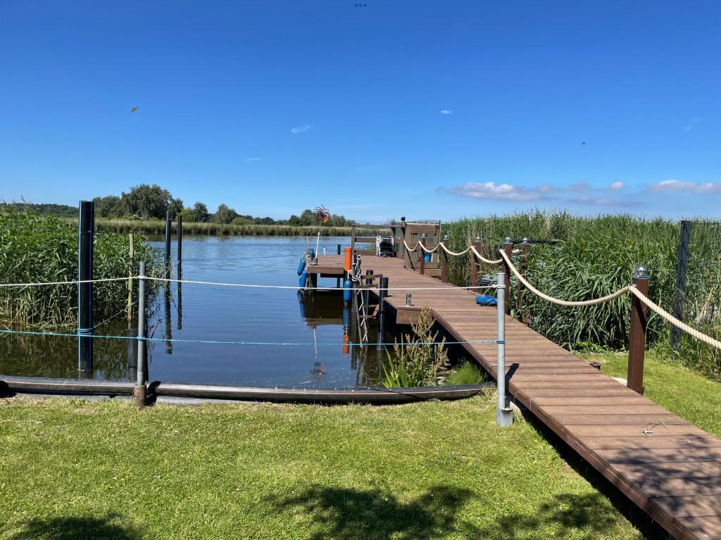 a dock with a boat on the water at Ostseehaus am Wasser in Barth