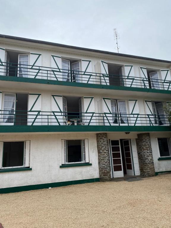 a building with balconies on the side of it at Les Tilleuls in Le Pouliguen