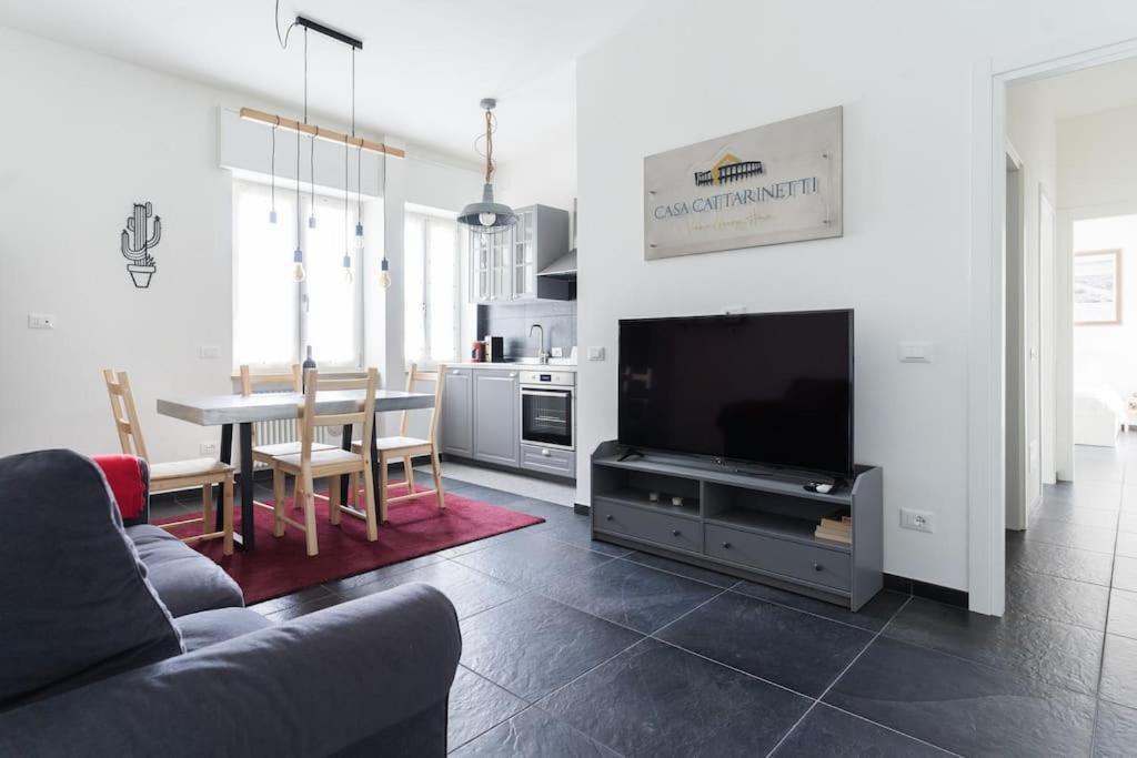 een woonkamer met een bank, een tafel en een televisie bij CASA CATTARINETTI - VERONA FIERA in Verona