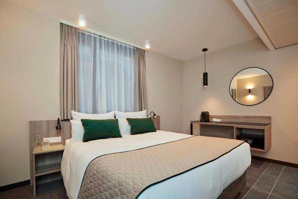 Łóżko lub łóżka w pokoju w obiekcie Leonardo Hotel Vienna City West
