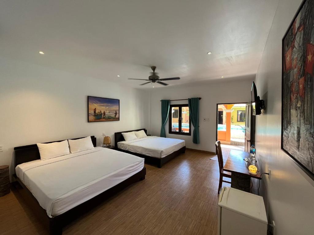 Giường trong phòng chung tại Mi Nhon Em Hotel Muine