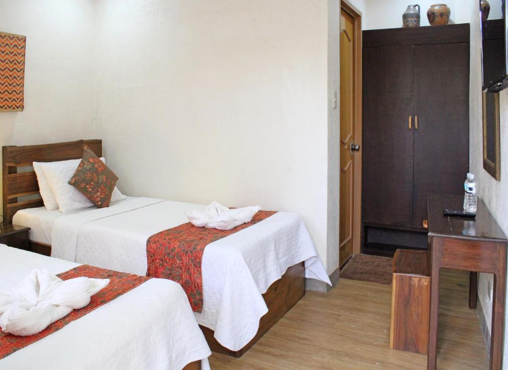 Postel nebo postele na pokoji v ubytování Balaibinda Lodge
