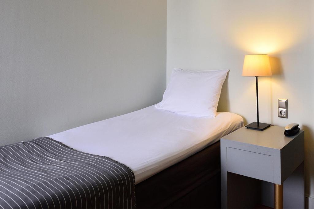 Postel nebo postele na pokoji v ubytování Le Palace Hotel