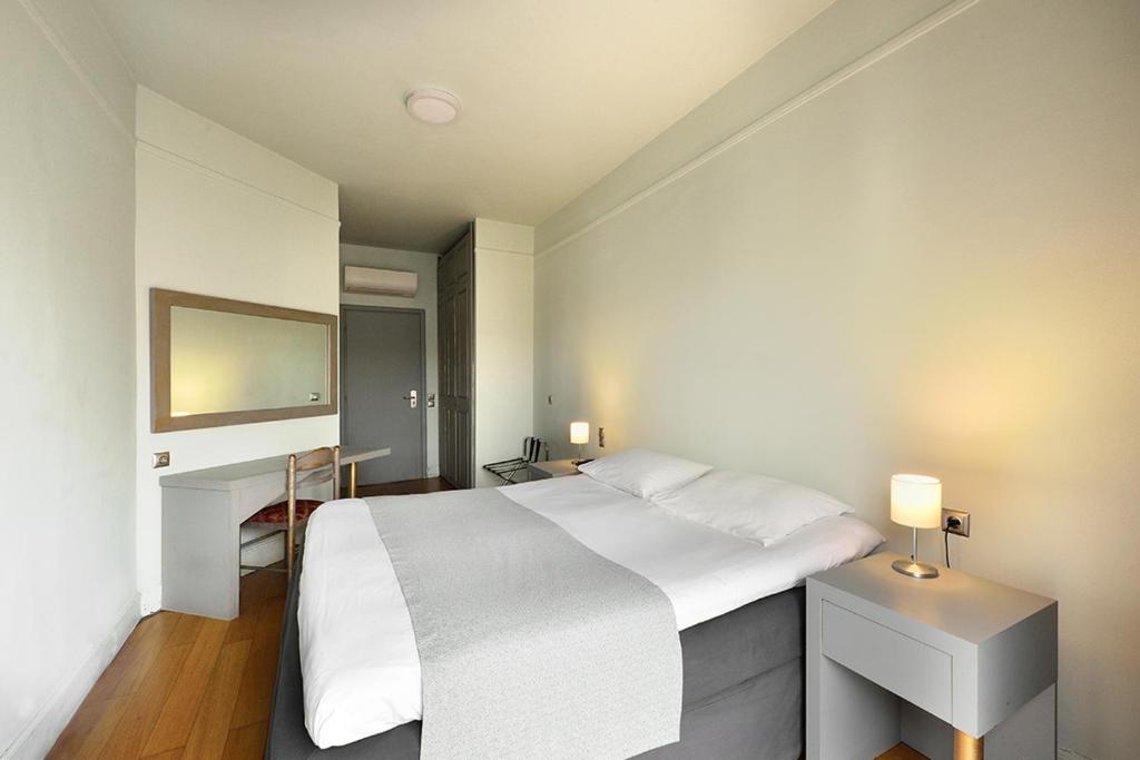 Postel nebo postele na pokoji v ubytování Le Palace Hotel