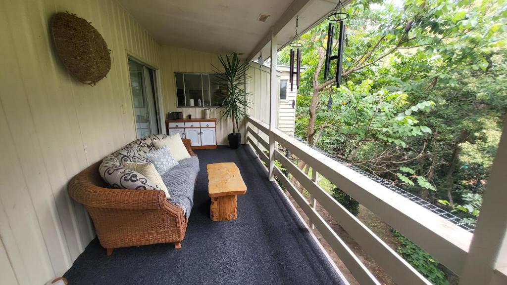 a porch with a couch and a coffee table at Nature's Melody Share Home in Brisbane