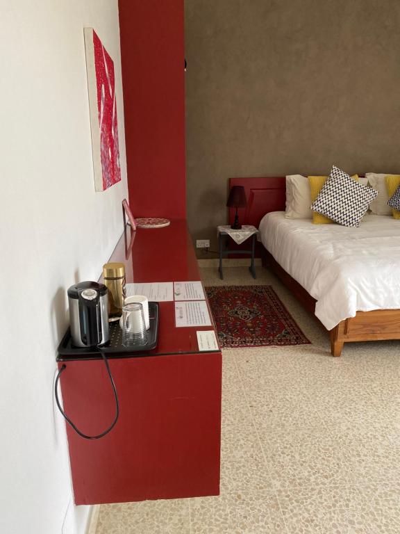 a living room with a bed and a table with a microwave at Home Sweet Home in St Julian's
