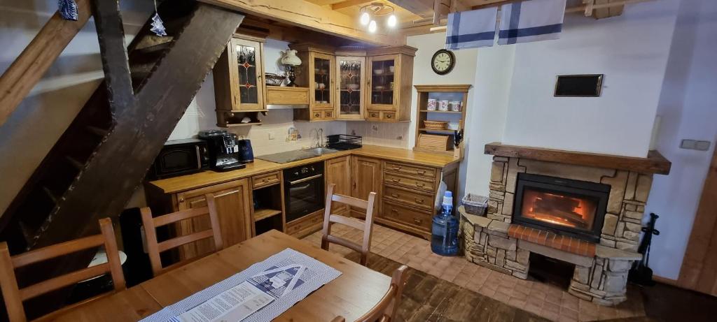 an overhead view of a kitchen with a fireplace at Palčovka Huty - apartmán U Ondry a U Andělky in Huty
