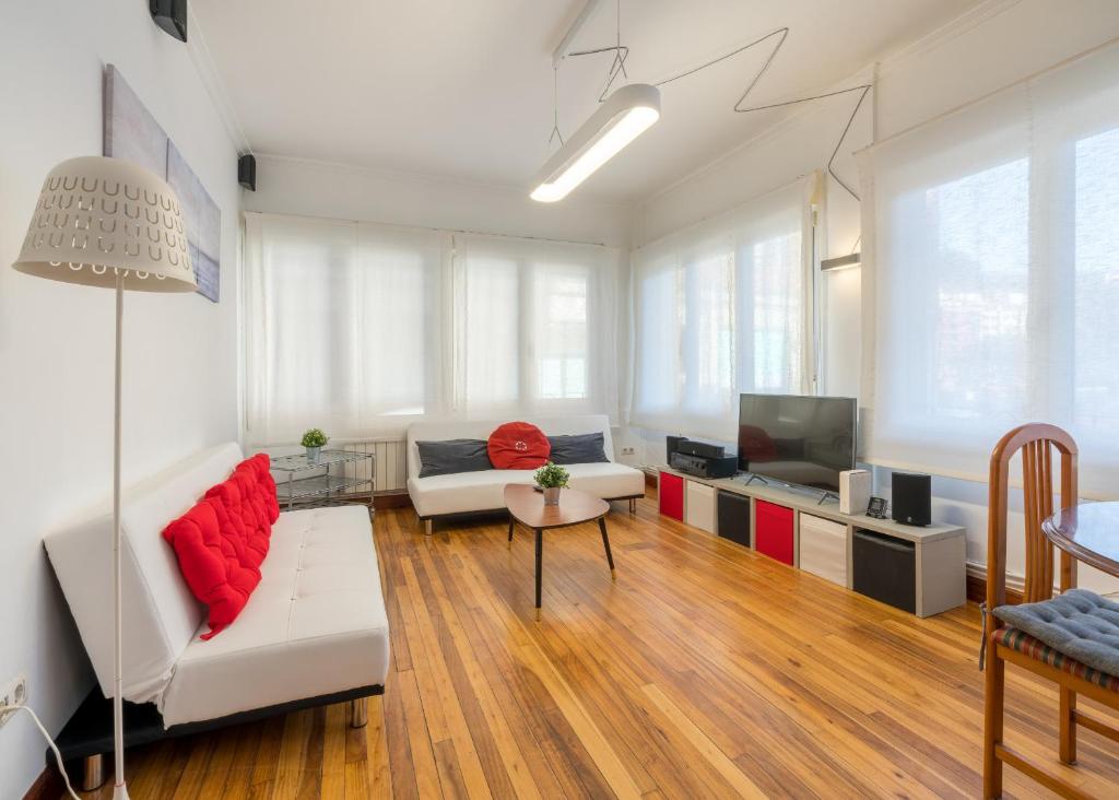 a living room with a couch and a tv at Ybarra apartment by People Rentals in Bilbao