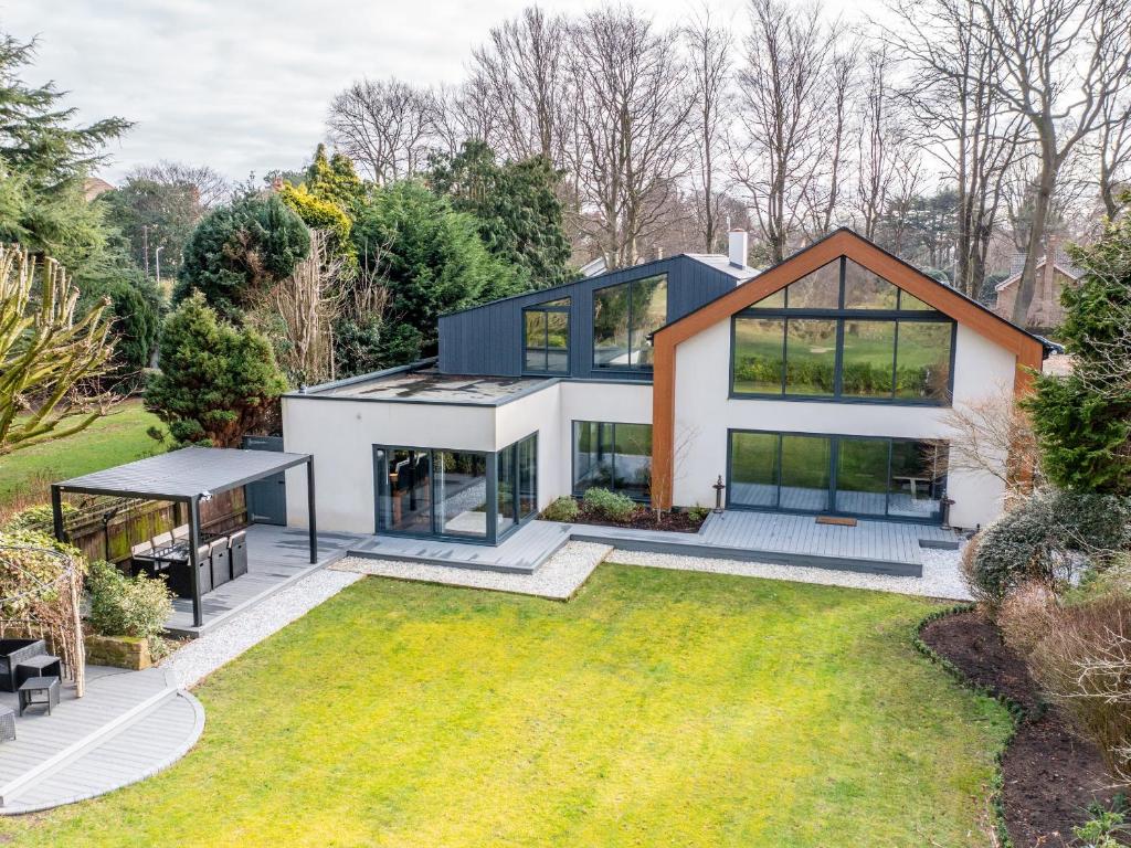 an image of a house with a garden at The Golf House in Bidston