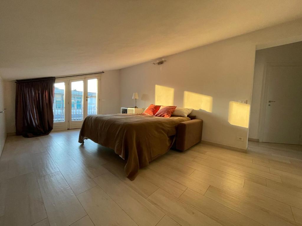 a large bedroom with a bed and a large window at Casa San Marco in Lucca