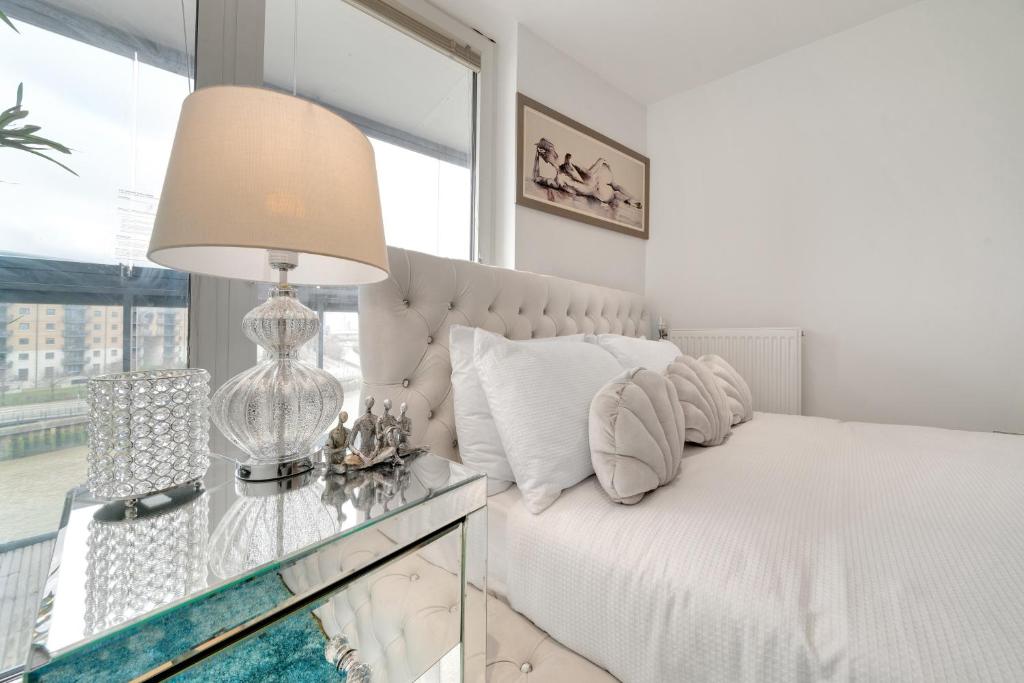 1 dormitorio con 1 cama y mesa de cristal con lámpara en Large 2Bed 2Bath Apartment Beautiful River Views London Greenwich Cutty Sark, en Londres