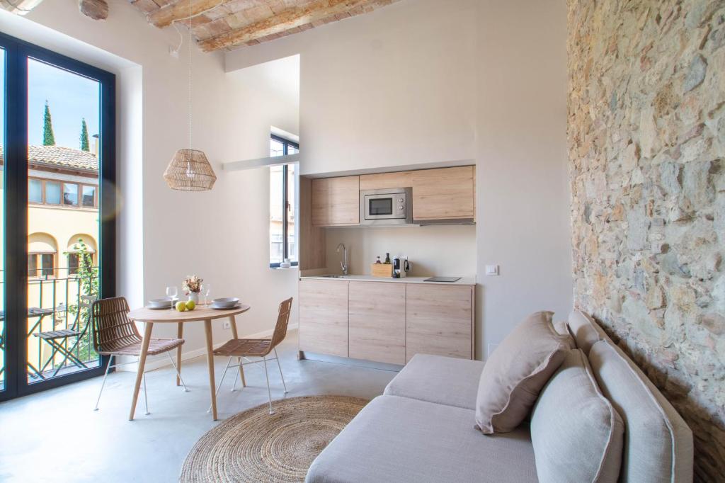 a living room with a couch and a table at Domina Boutique Apartment in Girona