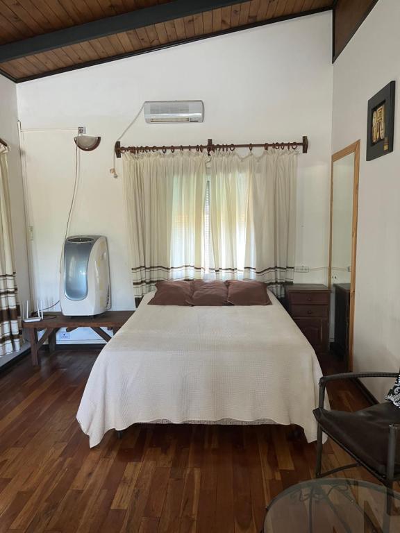 a bedroom with a bed and a tv in it at Departamento Porá in Puerto Iguazú