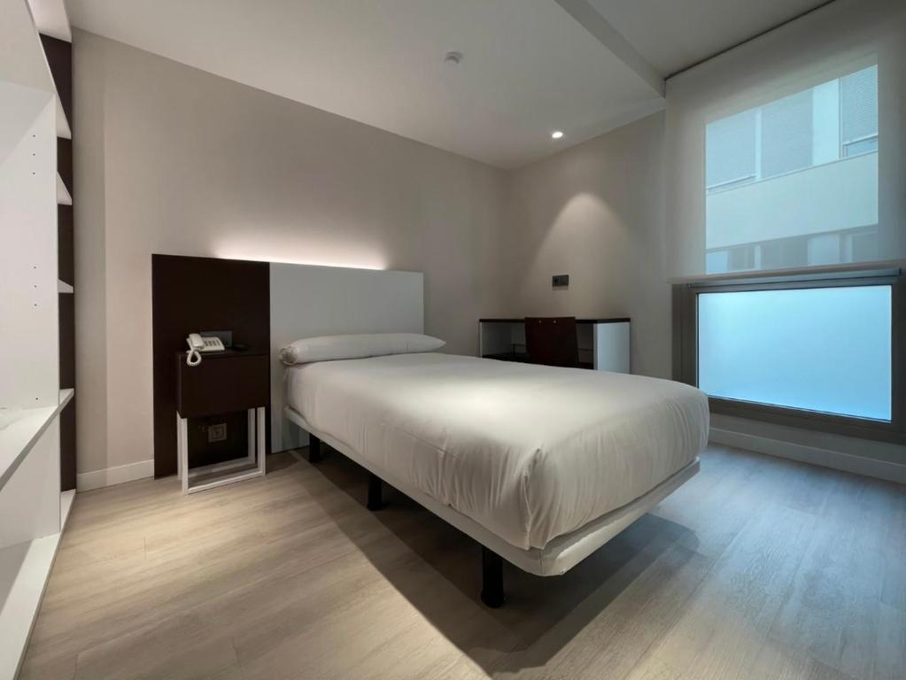 Postel nebo postele na pokoji v ubytování Hotel Remigio