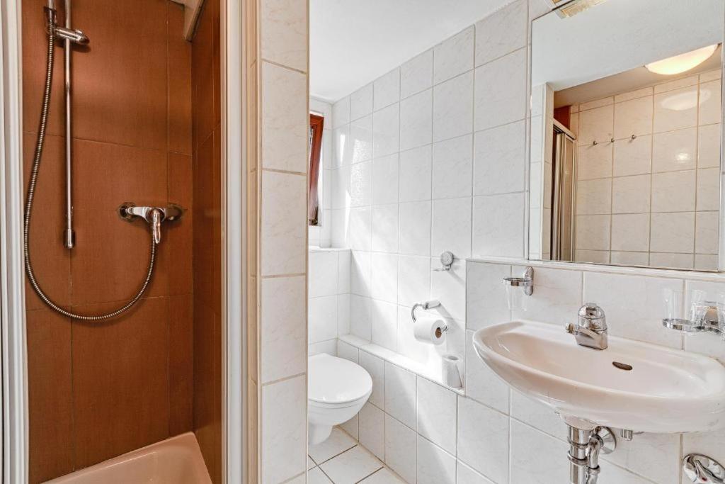 a bathroom with a sink and a toilet at Hotel La Ferté in Stuttgart