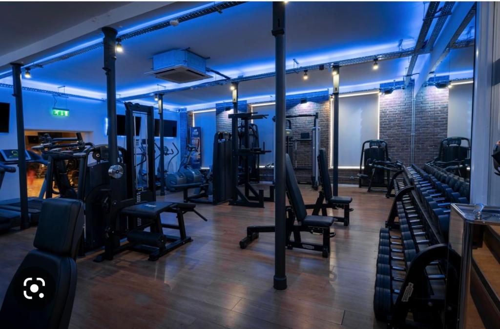 a gym with a bunch of equipment in a room at The Dog Inn in Longridge