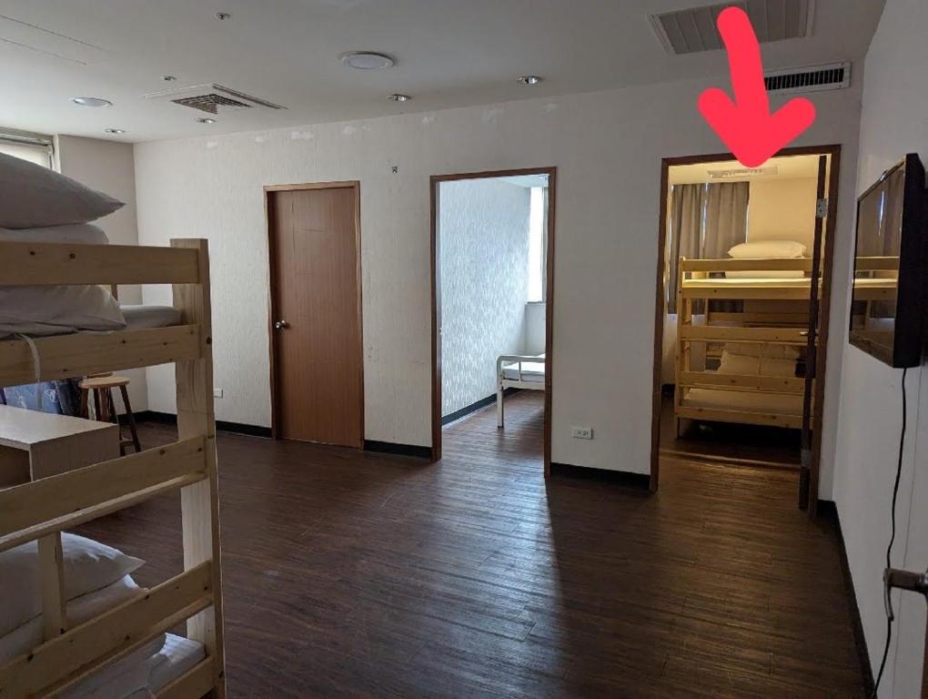 a room with bunk beds and a door with a red x at Hey Bear Capsule Hotel in Taipei