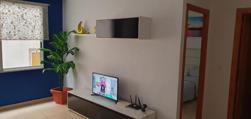 a living room with a tv on a wall at Apartamento Ciudad de las Ciencias in Valencia
