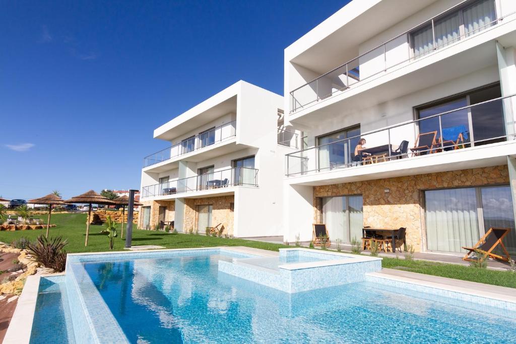 an image of a house with a swimming pool at Ericeira Surf Apartments in Ericeira
