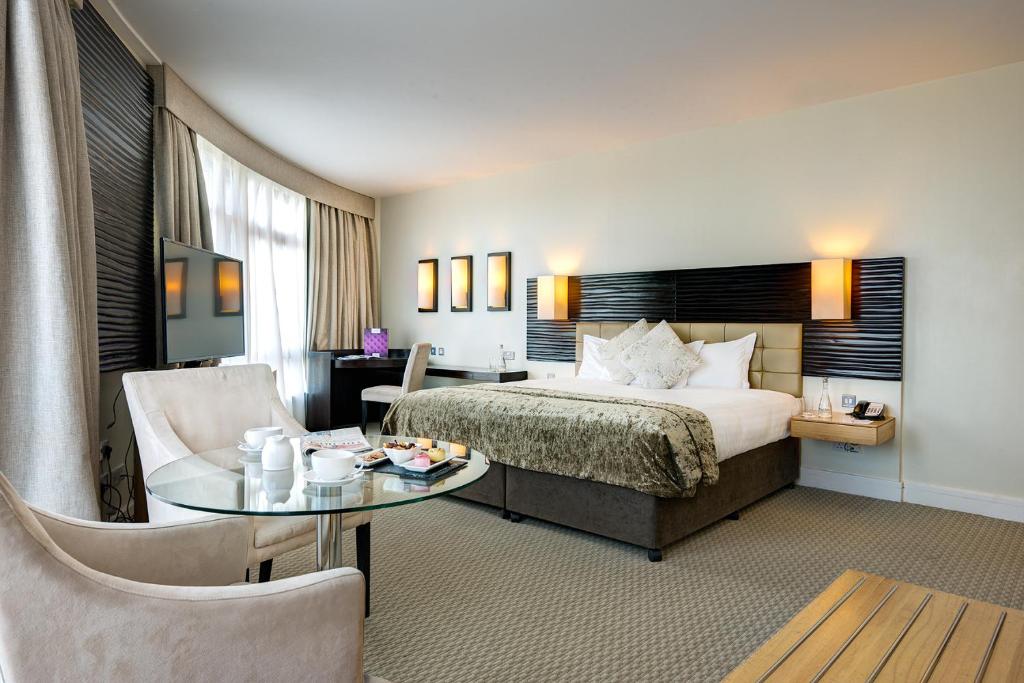 a hotel room with a bed and a table at Cork International Hotel in Cork