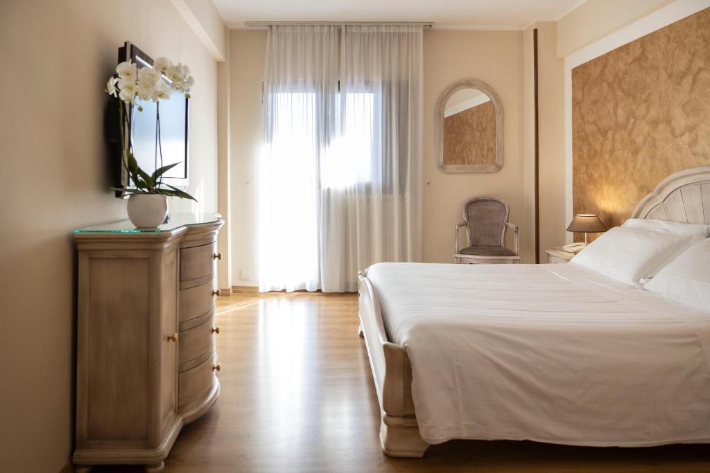 Postel nebo postele na pokoji v ubytování Grand Hotel del Parco