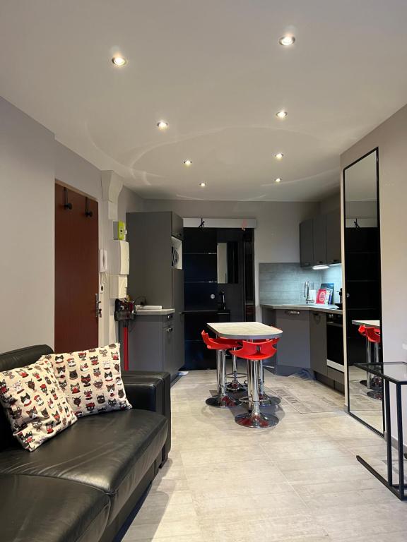 a living room with a couch and a table at Mandana in Évian-les-Bains