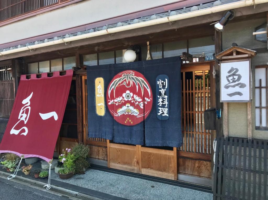 a store front with a flag and a sign on it at Kappo Ryokan Uoichi in Shimada