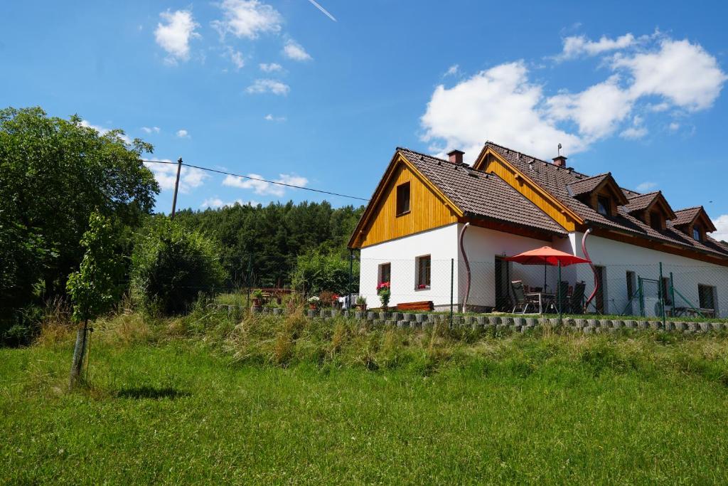 een klein wit huis met een rood dak bij apartmán pod Ještědem in Světlá pod Ještědem