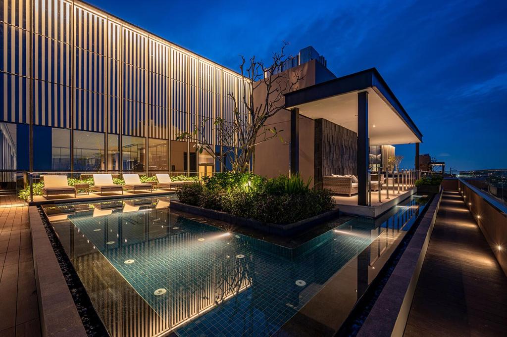 a house with a swimming pool in front of a building at Son&Henry The MarQ Luxury in Ho Chi Minh City