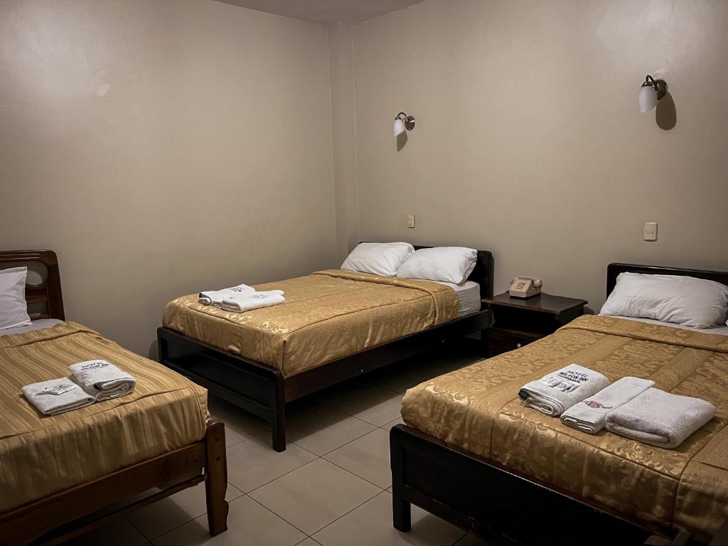 Postel nebo postele na pokoji v ubytování Hostal Wilson Inn