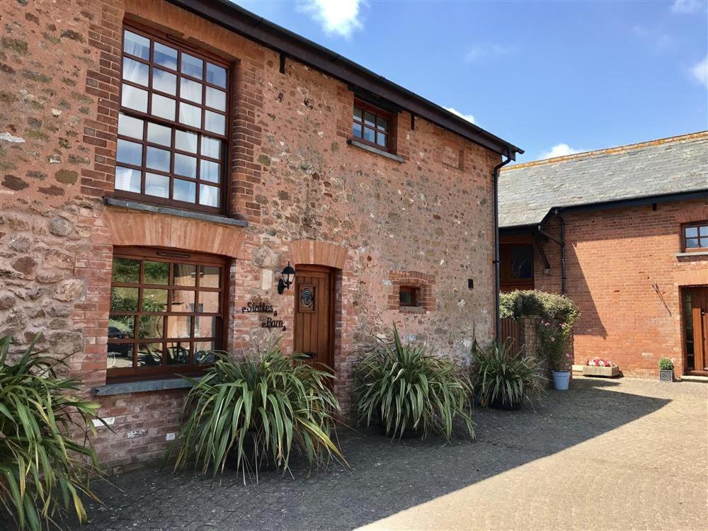 a brick building with plants in front of it at Stables Barn in East Budleigh