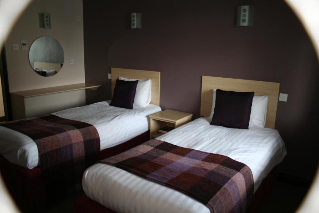 Postel nebo postele na pokoji v ubytování Yorkway Motel