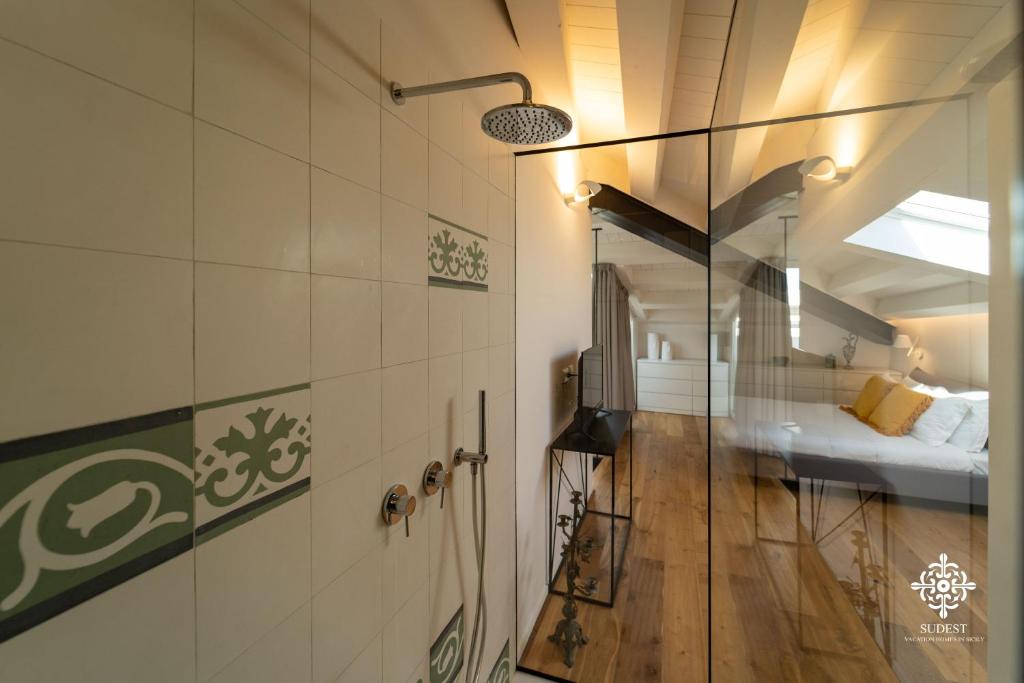 A bed or beds in a room at Suite Elios Ortigia