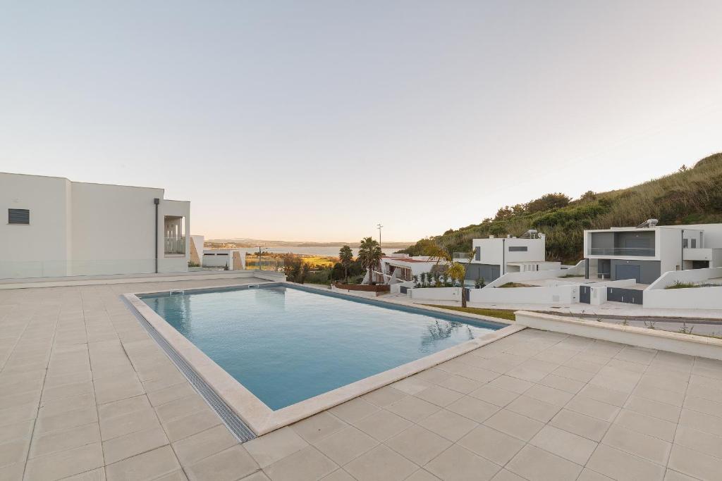 a villa with a swimming pool and white buildings at Lagoa Views - Holiday Apartment by SCH in Foz do Arelho