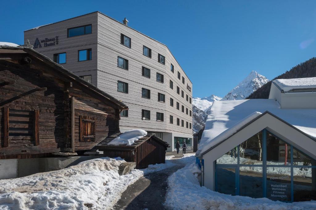 a large building with a snowboard on top of it at wellnessHostel4000 in Saas-Fee