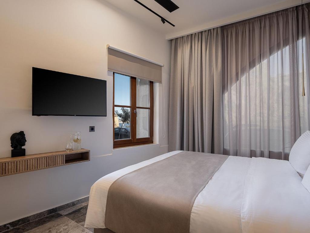 A bed or beds in a room at Ethos Suites