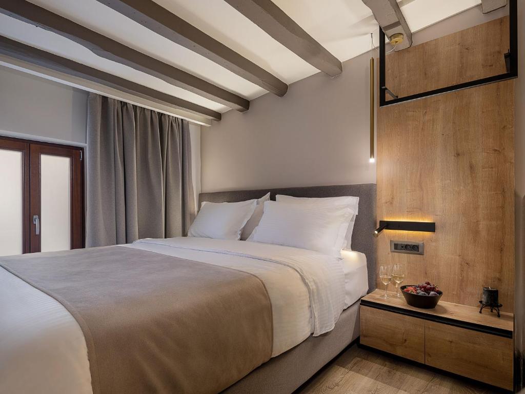 A bed or beds in a room at Ethos Suites