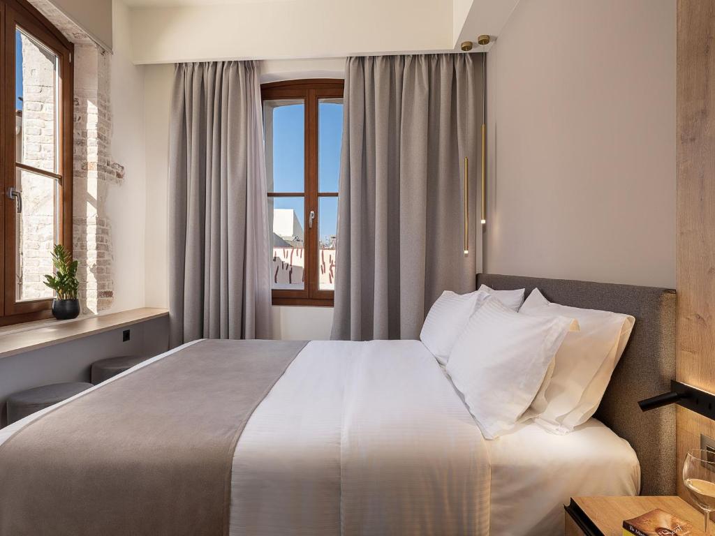 A bed or beds in a room at Ethos Suites