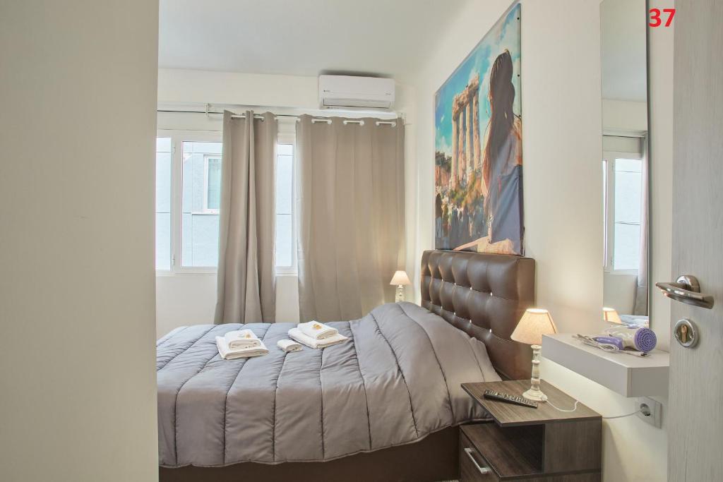 Postel nebo postele na pokoji v ubytování ATHENS COMMERCIAL