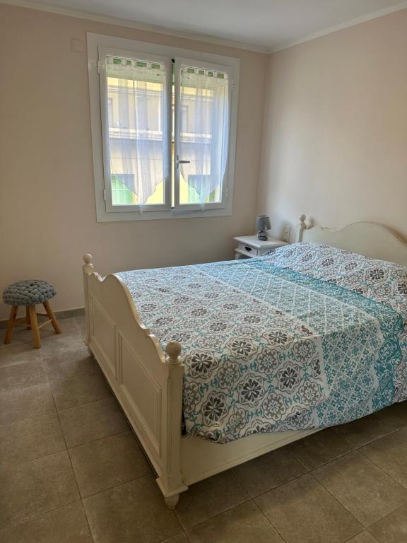 a bedroom with a bed with a comforter and a window at Appartement T3 centre ville in Bastia