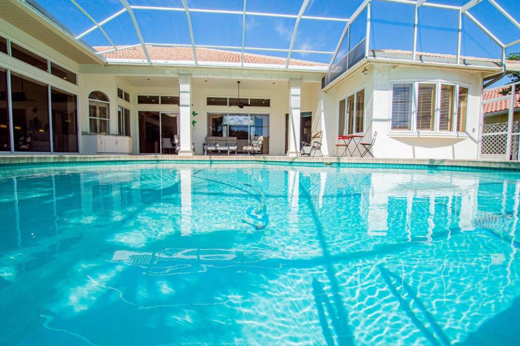 a swimming pool in a house with blue water at Fairway Haven in Wesley Chapel