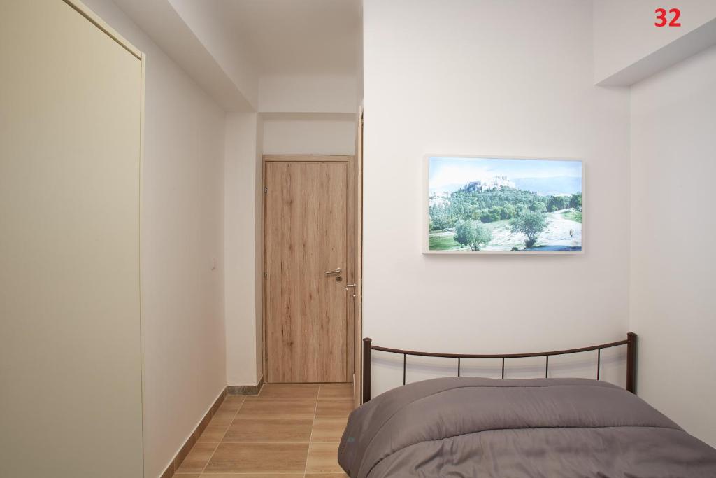 Postel nebo postele na pokoji v ubytování ATHENS COMMERCIAL