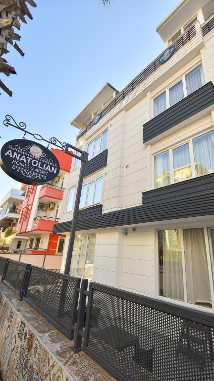 a building with a sign in front of it at Anatolian Homes & Apart in Antalya