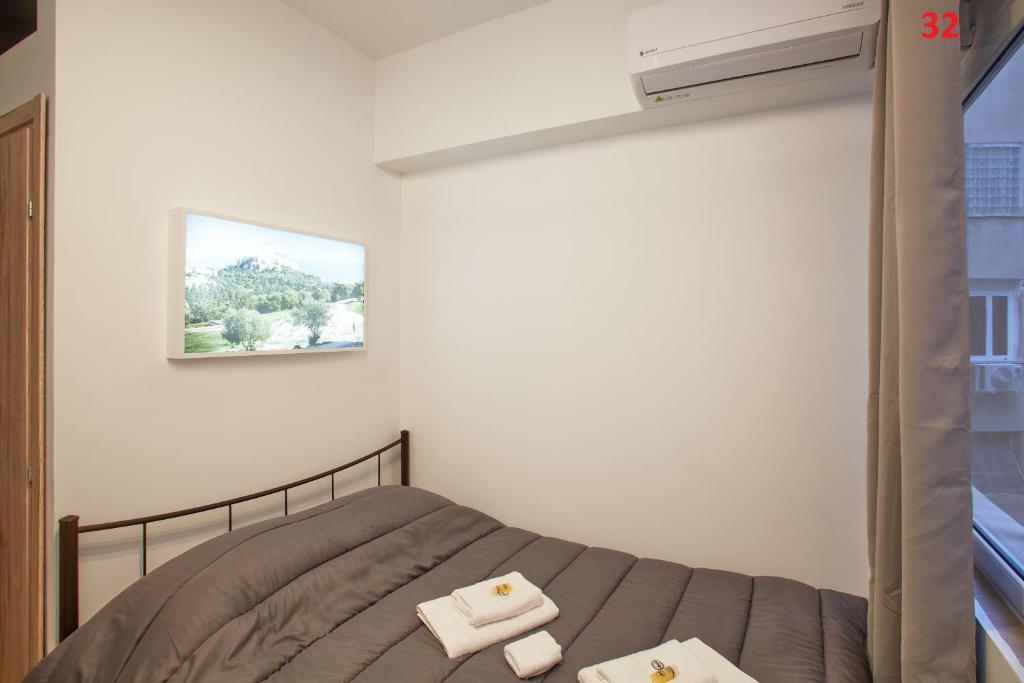 Postel nebo postele na pokoji v ubytování ATHENS COMMERCIAL