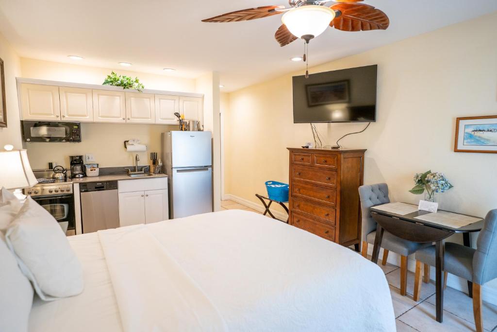 a kitchen with a refrigerator and a table in a room at The Capri at Siesta in Siesta Key