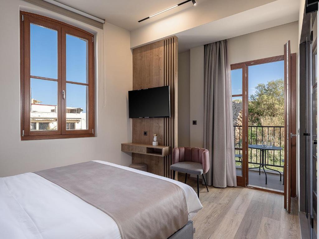 A bed or beds in a room at Ethos Suites