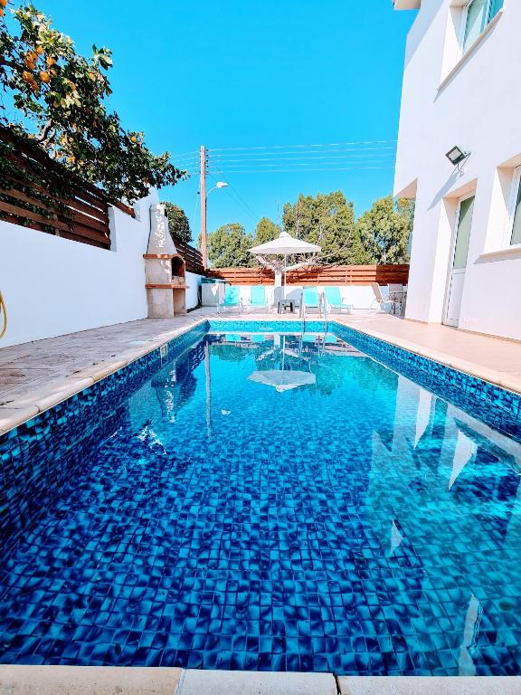 a swimming pool in a house with blue water at Villa Alkioni 31 in Paralimni