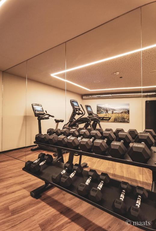 a gym with treadmills and dumbbells at Bergdorf Hotel Zaglgut in Kaprun