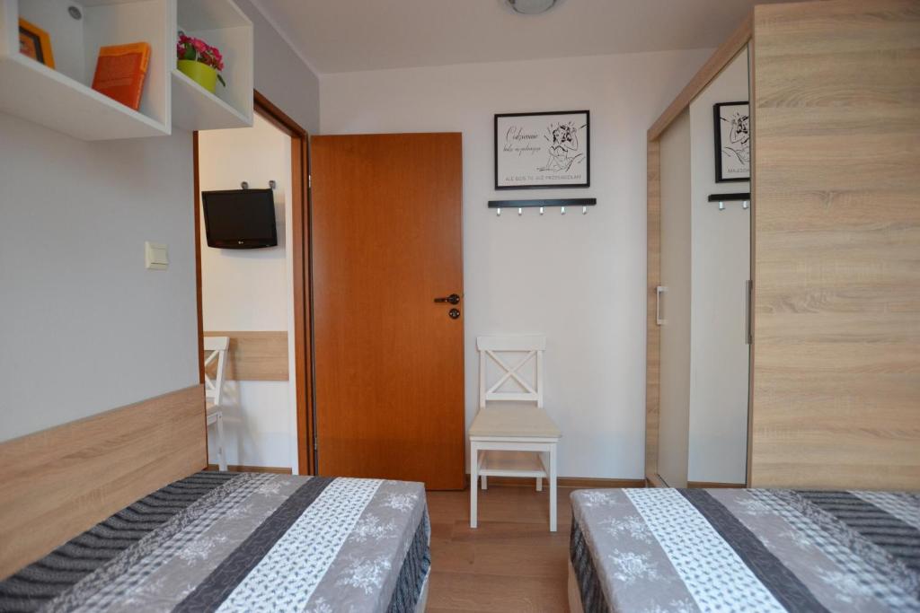 Posteľ alebo postele v izbe v ubytovaní Słoneczne Apartamenty w Poddąbiu